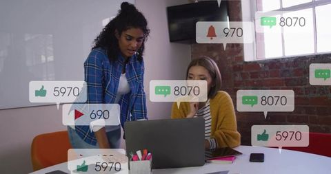 Professionals collaborating over laptop with social media engagement overlays