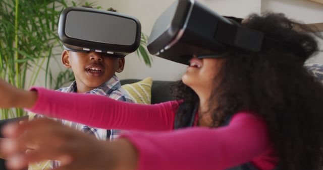 Children using virtual reality headsets, enjoying an immersive experience at home. This can be used to depict the excitement and engagement of young users with modern technology, suitable for advertising VR products, showcasing advances in gaming, or illustrating family-oriented technology use.