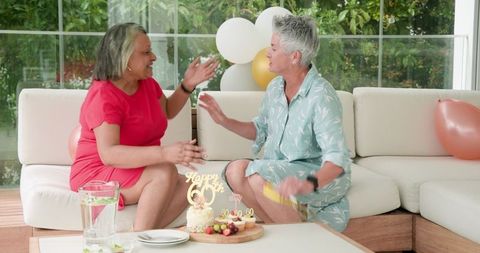 Joyful Senior Lesbian Couple Celebrating 60th Birthday