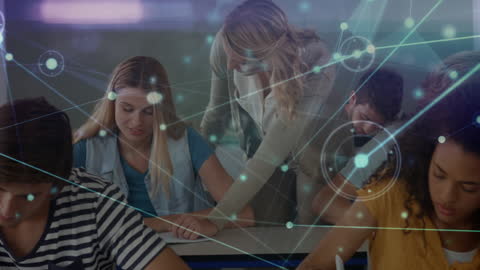 Teacher Assists Students with Digital Network Overlay in Classroom