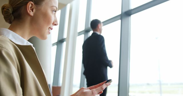 Professionals Waiting in Modern Office Building, Using Smartphone - Download Free Stock Images Pikwizard.com