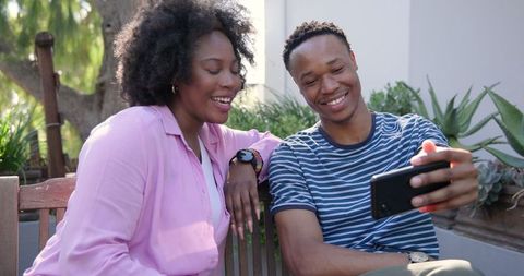 Smiling Couple Taking Selfie Outdoors Together