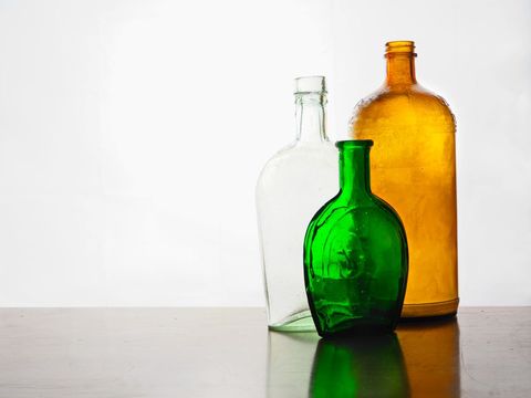 Vintage Glass Bottles on Glassy Surface