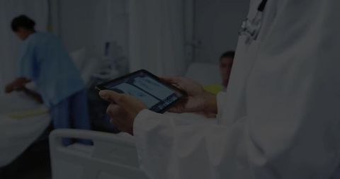 Doctor Holding Tablet for Consultation in Hospital Ward