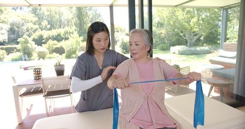 Senior Woman Rehab Exercising with Therapist Support