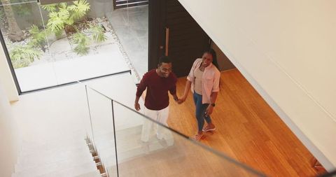 African american couple walking in modern home together