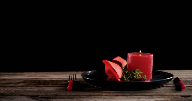 Romantic Table Setting with Red Candle, Rose Petals, and Black Plate - Download Free Stock Images Pikwizard.com