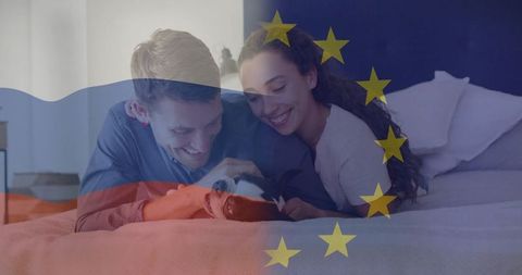 Young couple enjoying quality time with puppy on bedroom bed