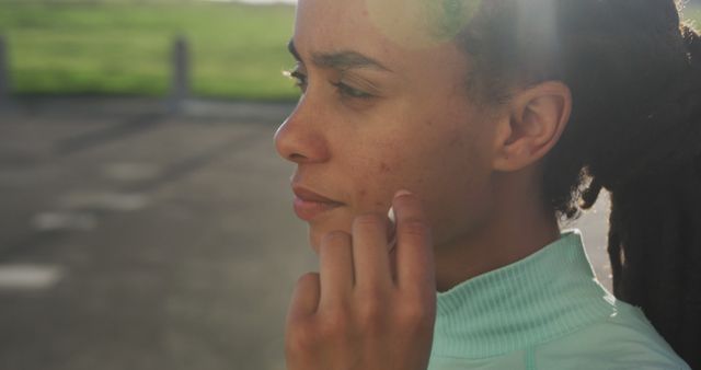 Woman with Dreadlocks Touching Face in Outdoor Setting - Download Free Stock Images Pikwizard.com