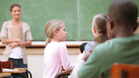 Children Collaborating in Classroom with Teacher
