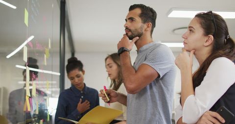 Team Brainstorming Session with Diverse Colleagues Using Sticky Notes