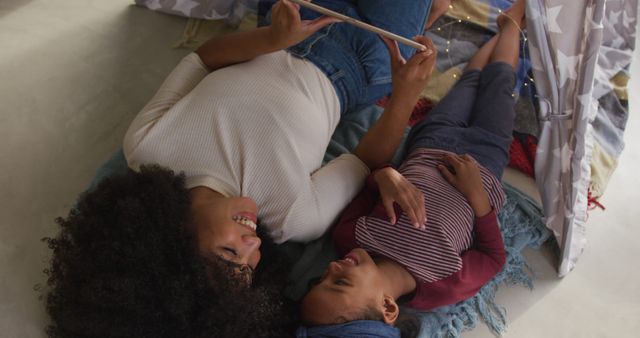 Mother and Daughter Reading Together in Makeshift Indoor Tent - Download Free Stock Images Pikwizard.com