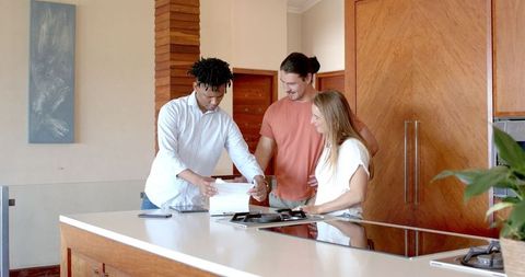 Friends Discussing Plans in Modern Kitchen Setting