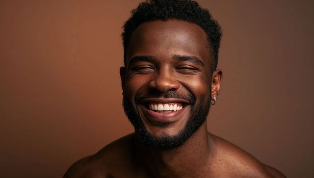 Smiling adult man showing teeth and warm expression closeup portrait with hoop earring
