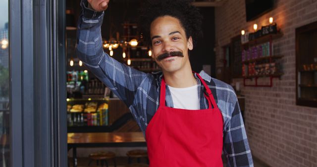 Smiling Barista Wearing Red Apron in Coffee Shop - Download Free Stock Images Pikwizard.com