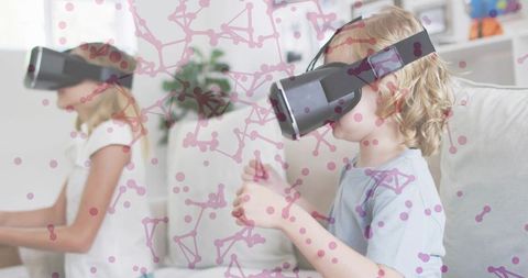 Children playing with vr headsets on sofa, siblings exploring virtual worlds together