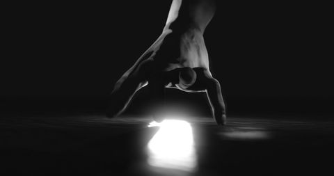 Creepy shadowy hand reaching towards light