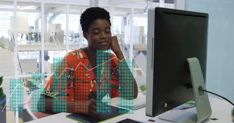 African American Businesswoman Analyzing Data on Computer in Modern Office
