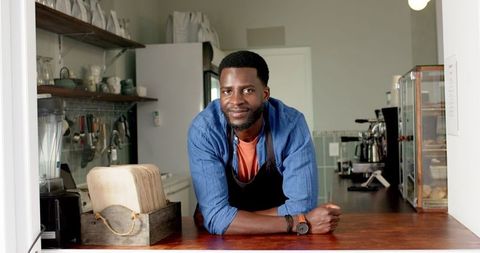 Friendly Barista Relaxing in Cozy Home Café