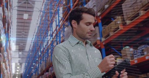 Warehouse Worker Scanning Boxes for Efficient Inventory Management