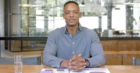 Confident Businessman Presenting Corporate Strategy in Modern Office