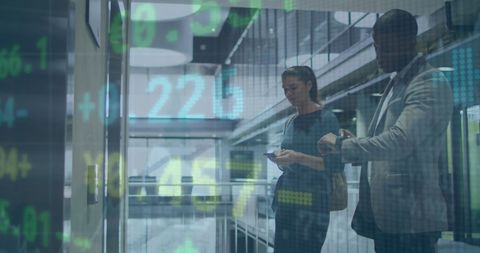 Business professionals in modern office with stock market overlay