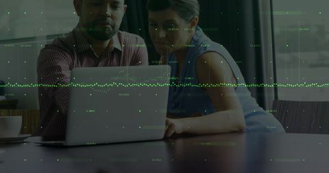 Diverse Colleagues Analyzing Financial Data on Laptop