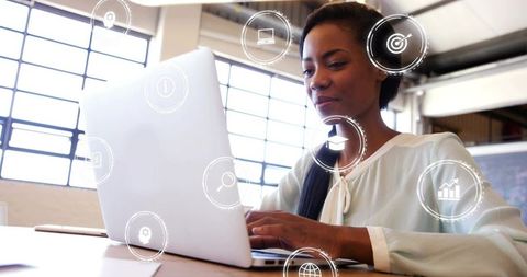 Businesswoman Analyzing Data on Laptop in Modern Office with Tech Icons