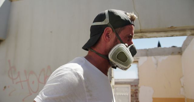 Construction Worker Wearing Safety Mask in Partially Rebuilt Building - Download Free Stock Images Pikwizard.com