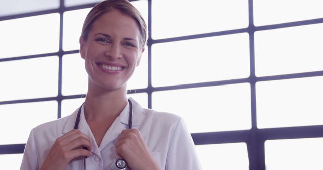 Smiling Female Doctor with Stethoscope in Hospital Setting - Download Free Stock Images Pikwizard.com