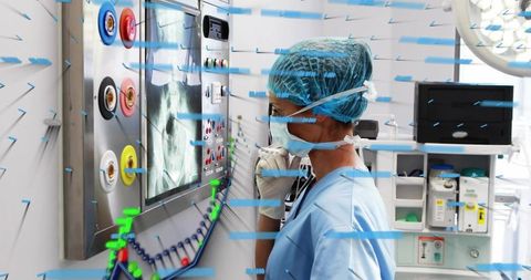 Clinician studying chest X-ray with AI data overlay in sterile operating room monitor