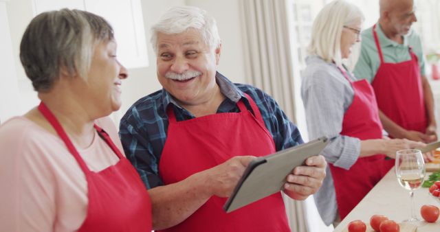 Senior Friends Cooking and Using Tablet in Kitchen - Download Free Stock Images Pikwizard.com