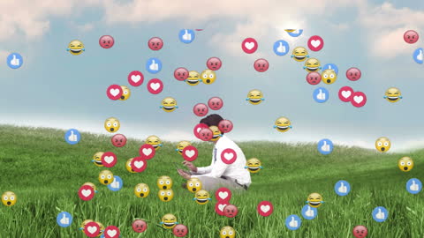 Businessman Engaged with Social Media Emojis in Green Field