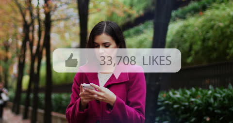 Woman Engaging on Social Media While Strolling in Park