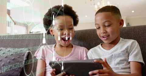Children using tablet on sofa exploring augmented reality learning and play