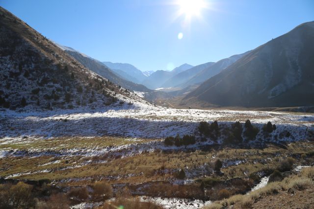 Sunlit Mountain Valley with Snow and Blue Sky - Download Free Stock Photos Pikwizard.com