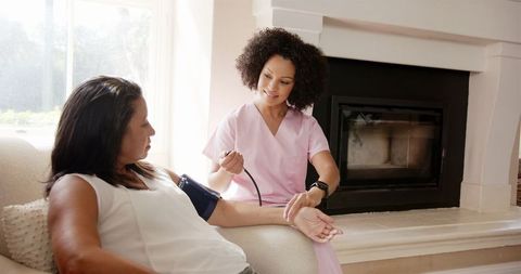 Nurse Checking Blood Pressure of Patient at Home