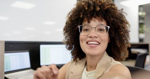 Cheerful Businesswoman in Modern Office Environment Smiling