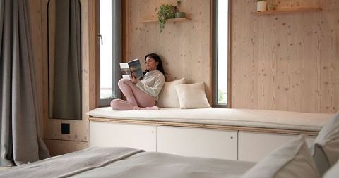 Ample Natural Light in Modern Bedroom Balances with Wooden Interiors for Cozy Feel