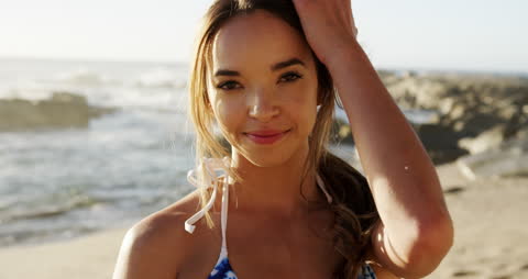 Cheerful Woman at Beach with Ocean Background