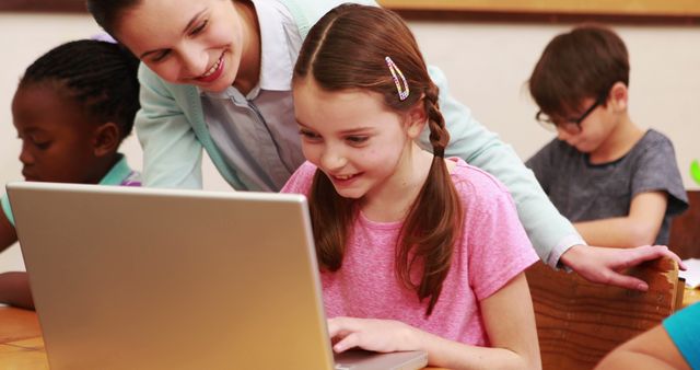 Young Students Learning with Teacher in Classroom Using Laptops - Download Free Stock Images Pikwizard.com