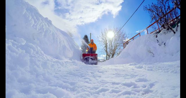 Person using snow blower on snowy driveway during winter - Download Free Stock Images Pikwizard.com