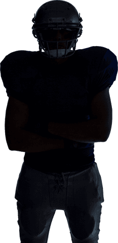 American football player standing in silhouette on transparent background