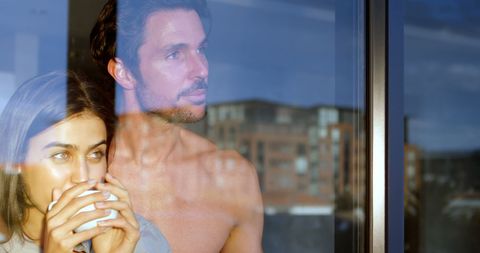 Couple Reflective Gaze Through Window With Coffee