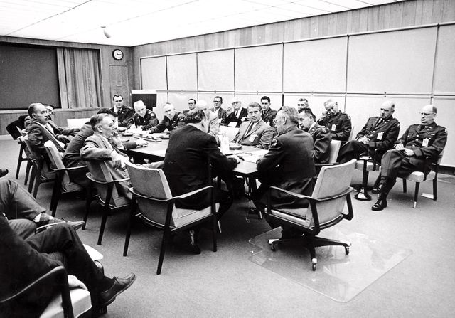 In this picture, negotiations are under way between officials of the Army Ballistic Missile Agency (ABMA) and the National Aeronautics and Space Administration (NASA) on August 11, 1959. Seated at the table with his back to the camera, is Dr. T. Keith Glernan, NASA Administrator. At the head of the table is Major General John Barclay, Commander of ABMA and at the right side of the table are Colonel John G. Zierdt of ABMA and Dr. von Braun. 