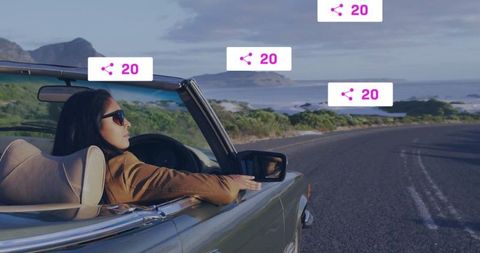 Woman driving convertible on coastal highway journey