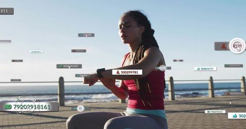 Woman checking smartwatch during outdoor workout on seaside promenade with data overlays