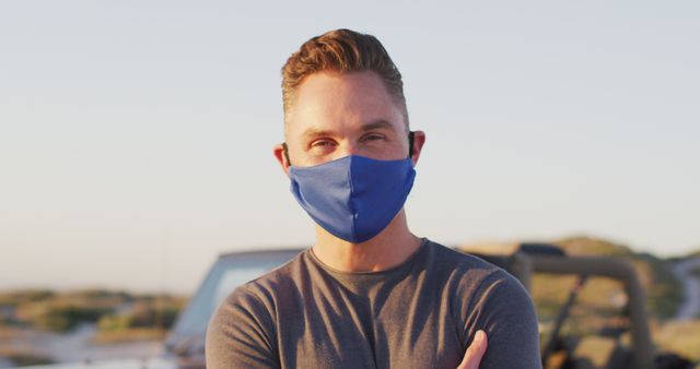 Man Wearing Face Mask Smiling Outdoors with Sunlight in Background - Download Free Stock Images Pikwizard.com