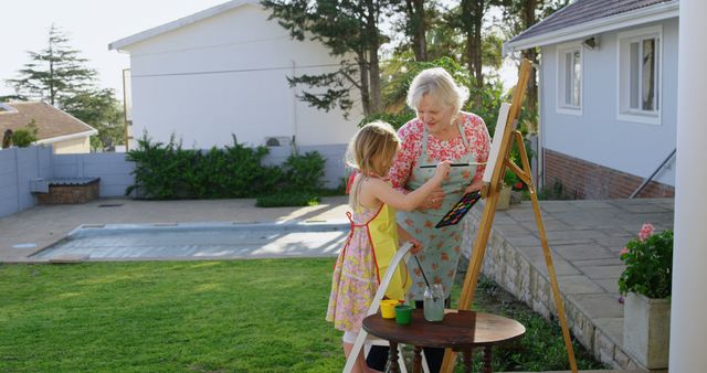 Grandmother and Granddaughter Painting Together Outdoors - Download Free Stock Images Pikwizard.com