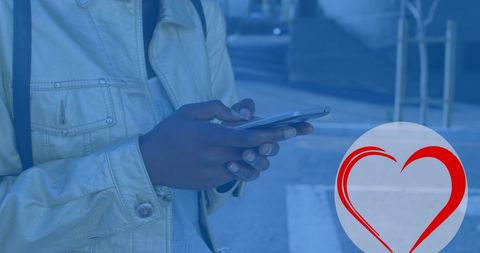 Young Adult Focused on Smartphone with Heart Graphic Overlay - Download Free Stock Images Pikwizard.com